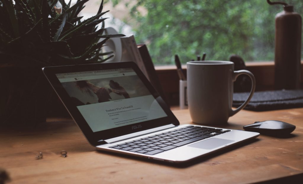 laptop and mug on a home desk
